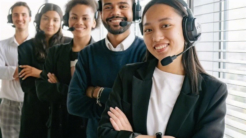 How Customer Service AI Agents Are Redefining Support Efficiency 1 A diverse team of five customer service agents wearing headsets, smiling confidently with their arms crossed in an office setting.