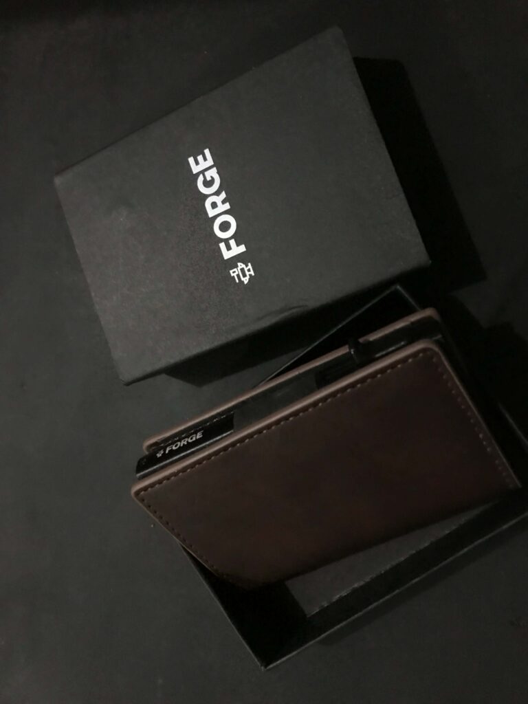 A technical 3D image demonstrating the dual-plate construction of the Forge Wallet, designed to provide 360-degree RFID blocking for secure condo and city living.