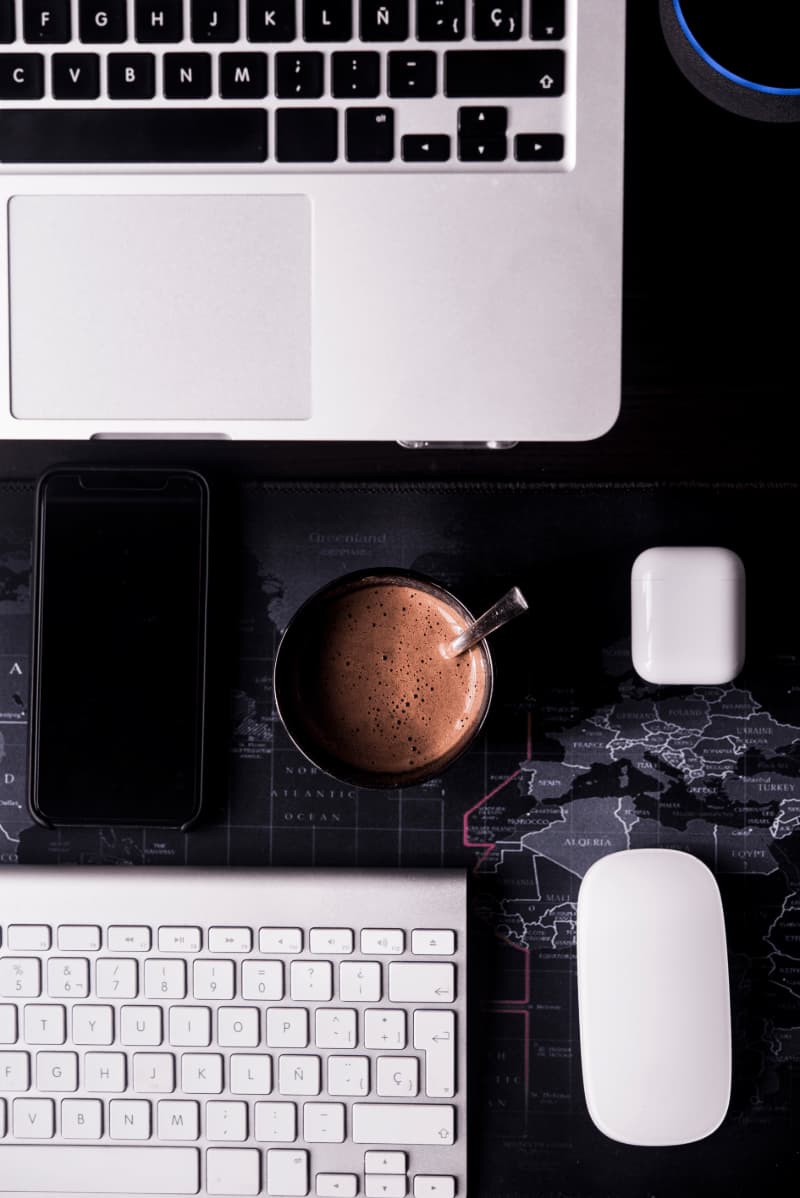 brown ceramic mug on macbook