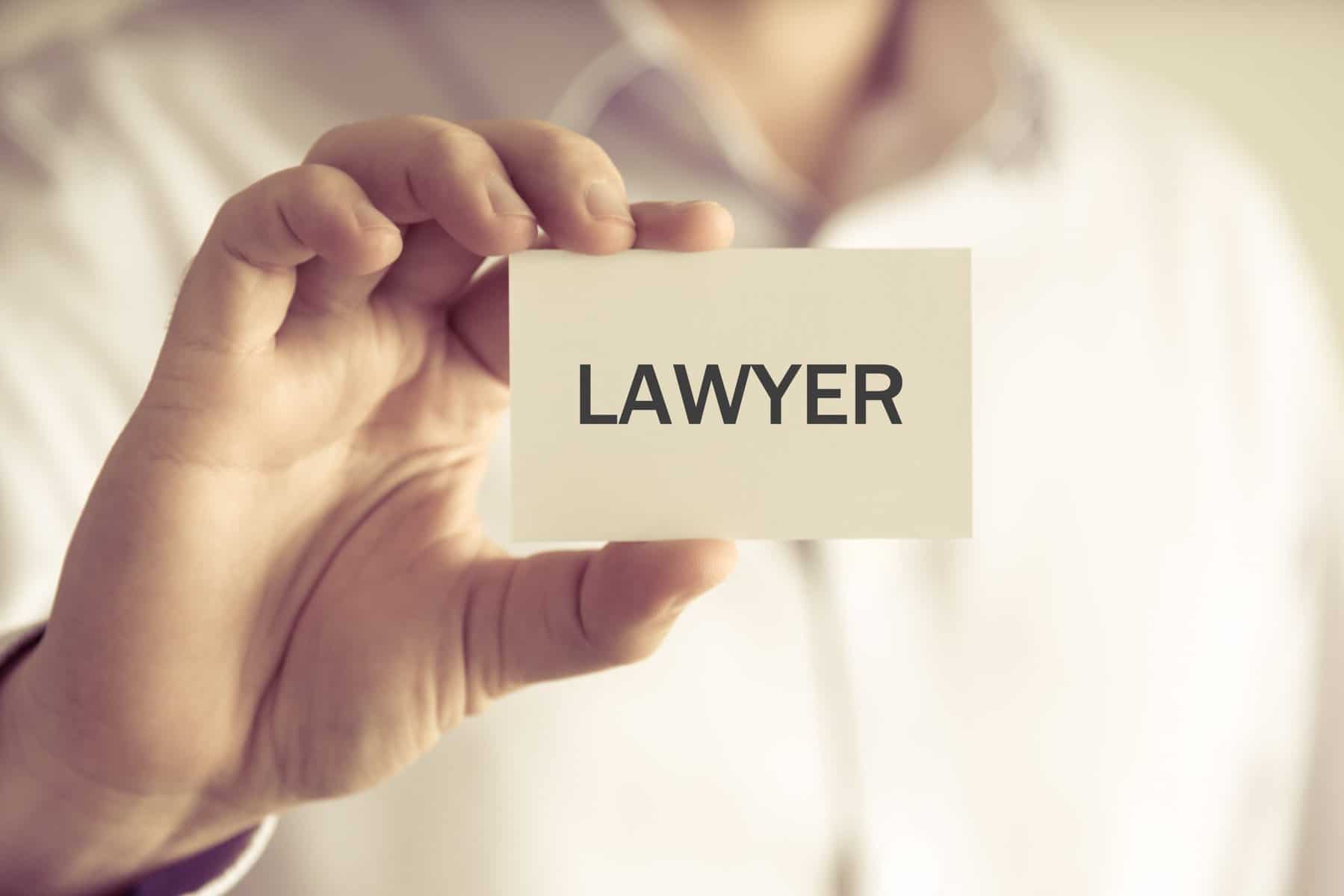 person holding card with lawyer written scopIO scaled 1