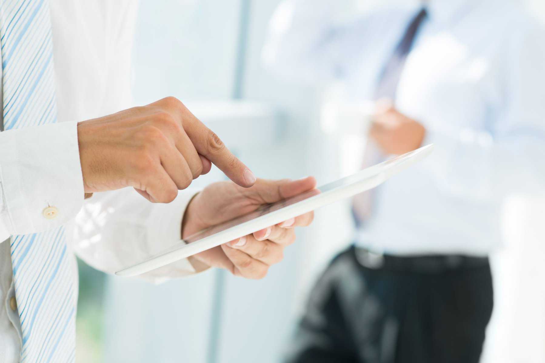 person holding white tablet scopIO scaled 1