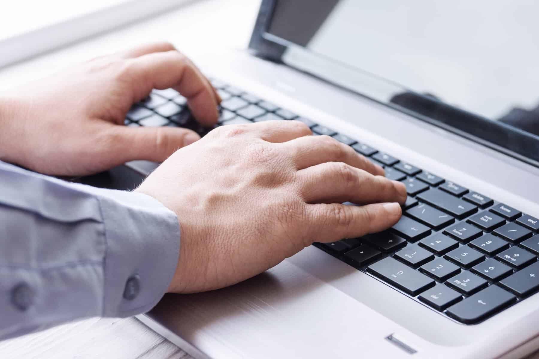 person using laptop scopIO 1 scaled 1