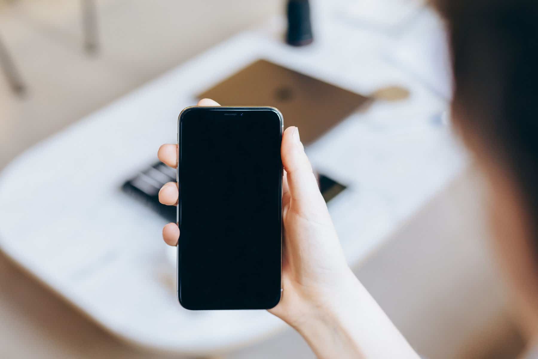 person holding phone scopIO scaled 1