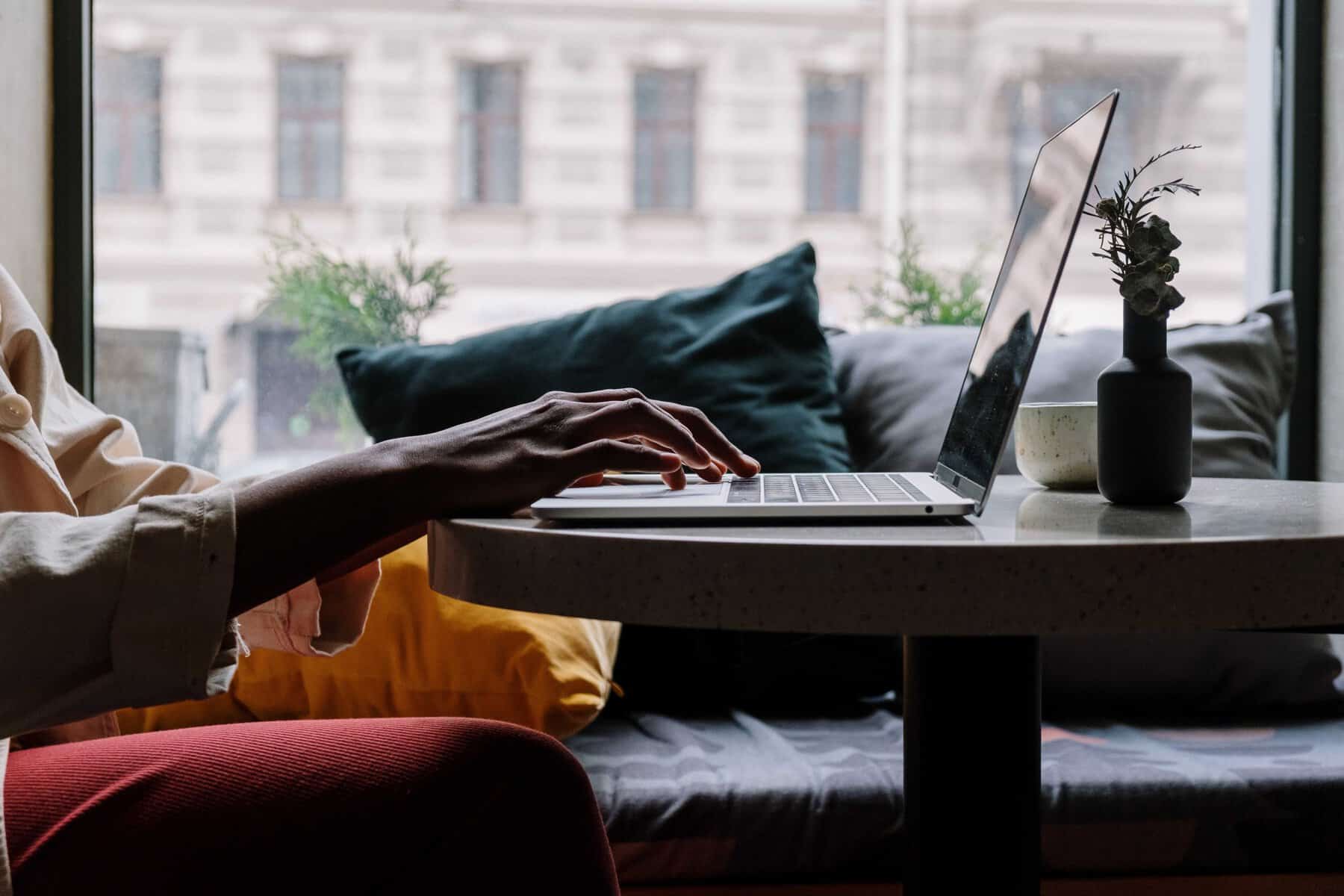 person in orange using laptop scopIO scaled 1