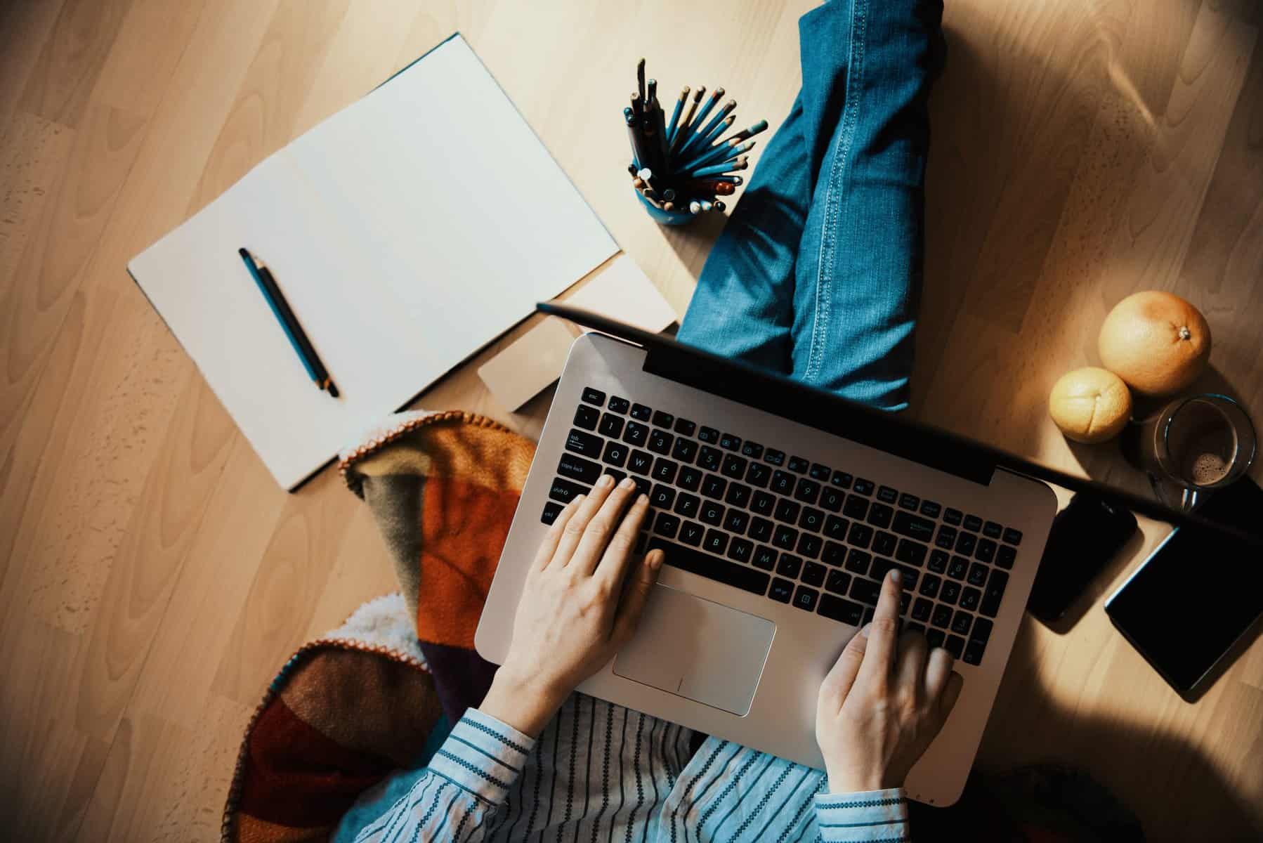 person using laptop on the floor scopIO scaled 1