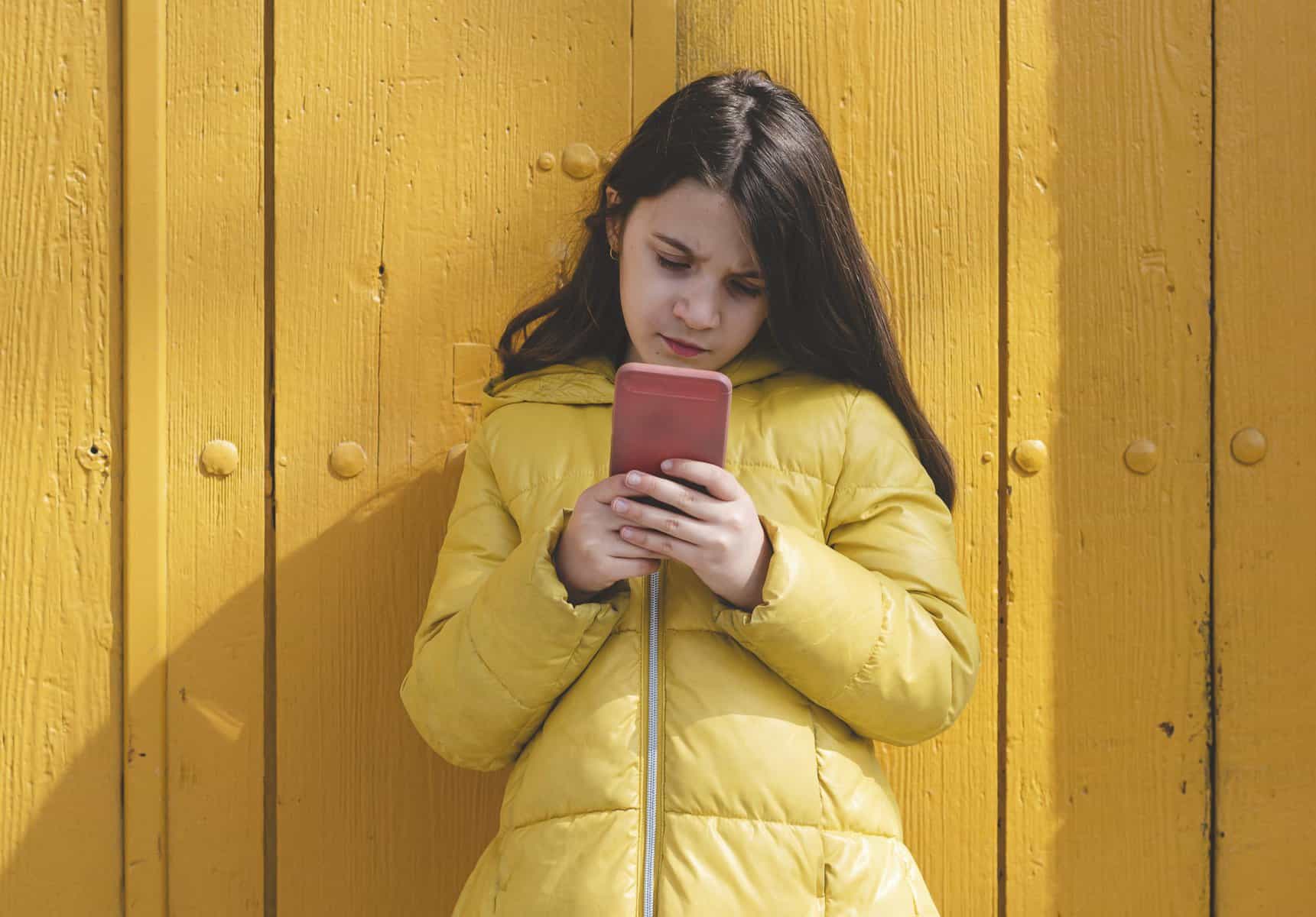 woman in yellow using phone scopIO scaled 1
